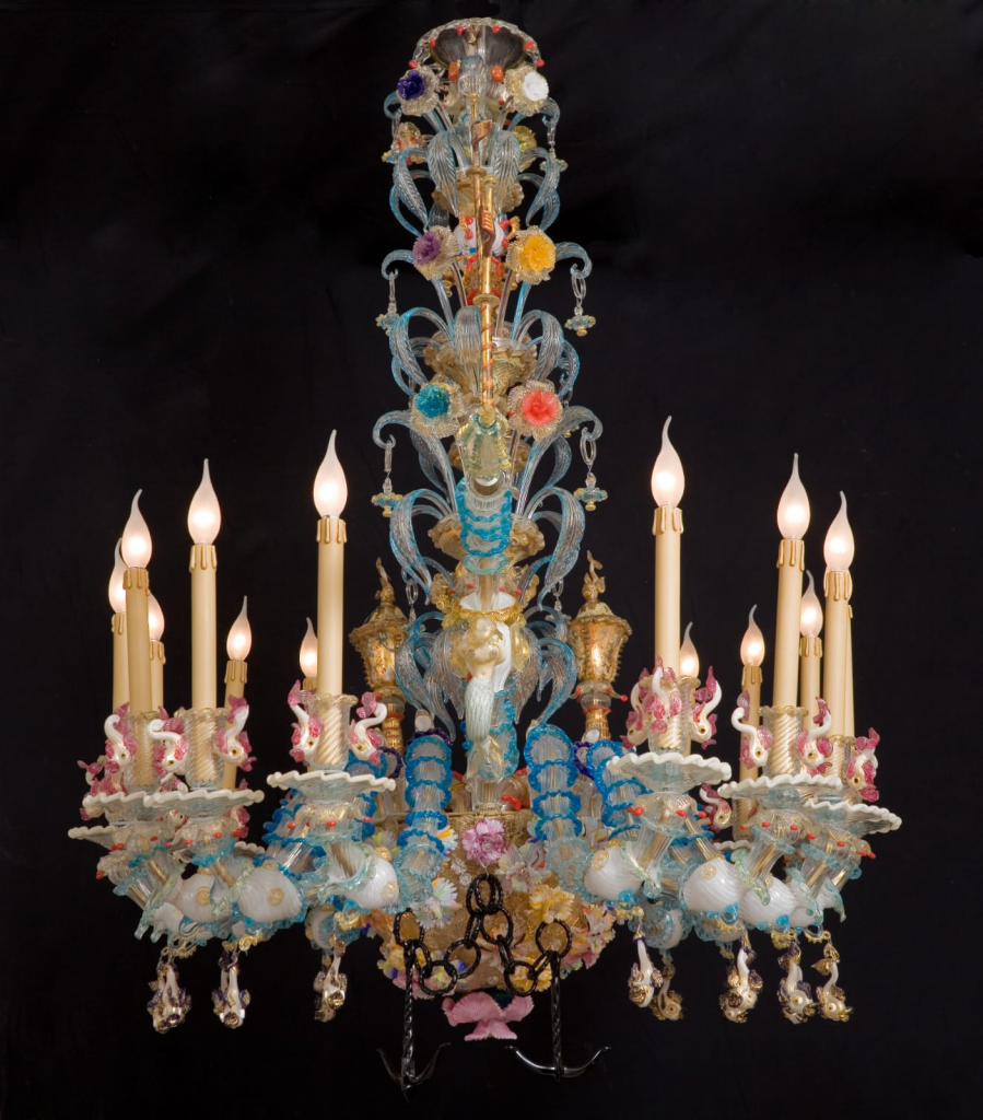 Large Venetian glass chandelier with four colored candles and crystal details, known as a Rezzonico chandelier